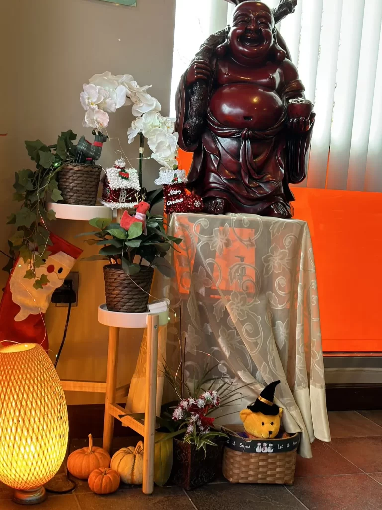 Laughing Buddha with seasonal ornaments at Peking Garden, a Chinese Restaurant in Sumner
